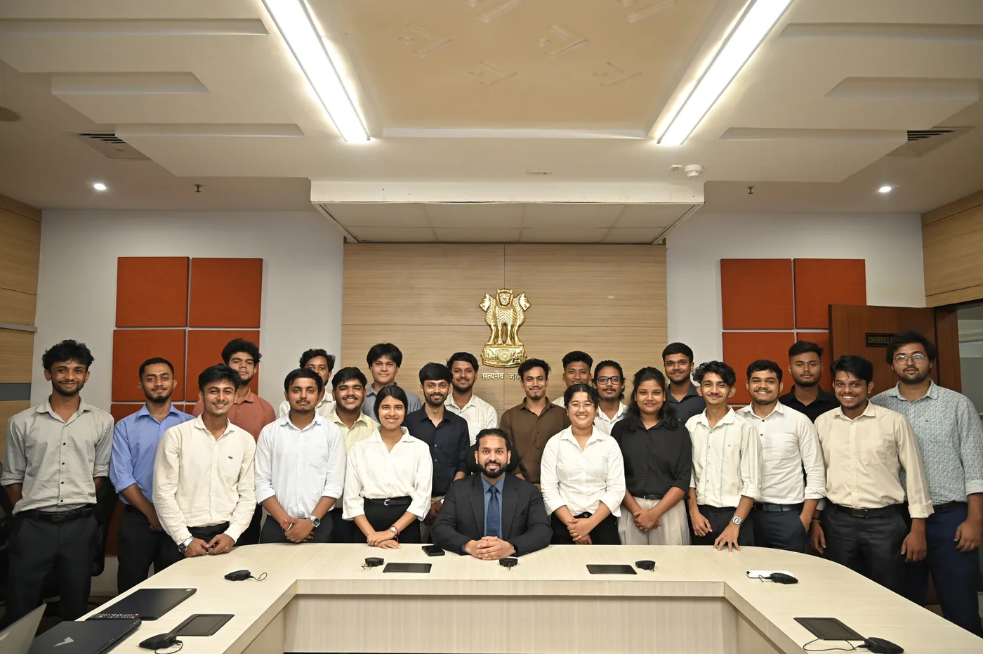 Ashwani Kumar with a group of interns in a conference room