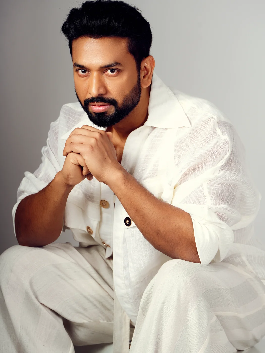 Studio portrait of Ashwani Kumar in white linen